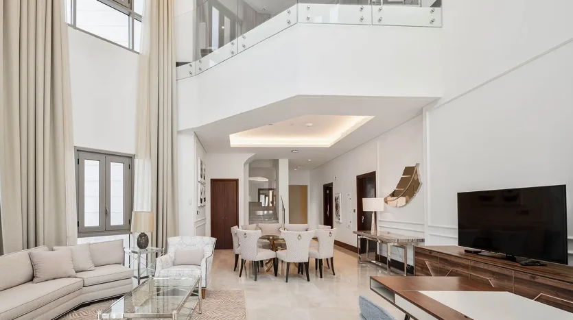 Bright living room with dining area and glass balcony