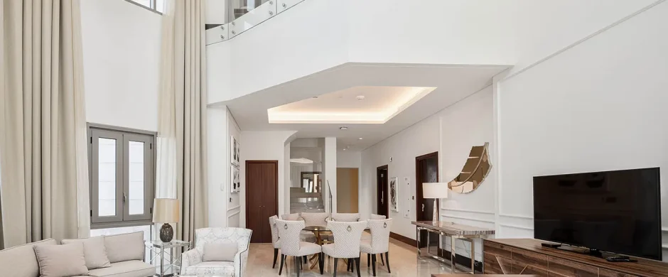 Bright living room with dining area and glass balcony