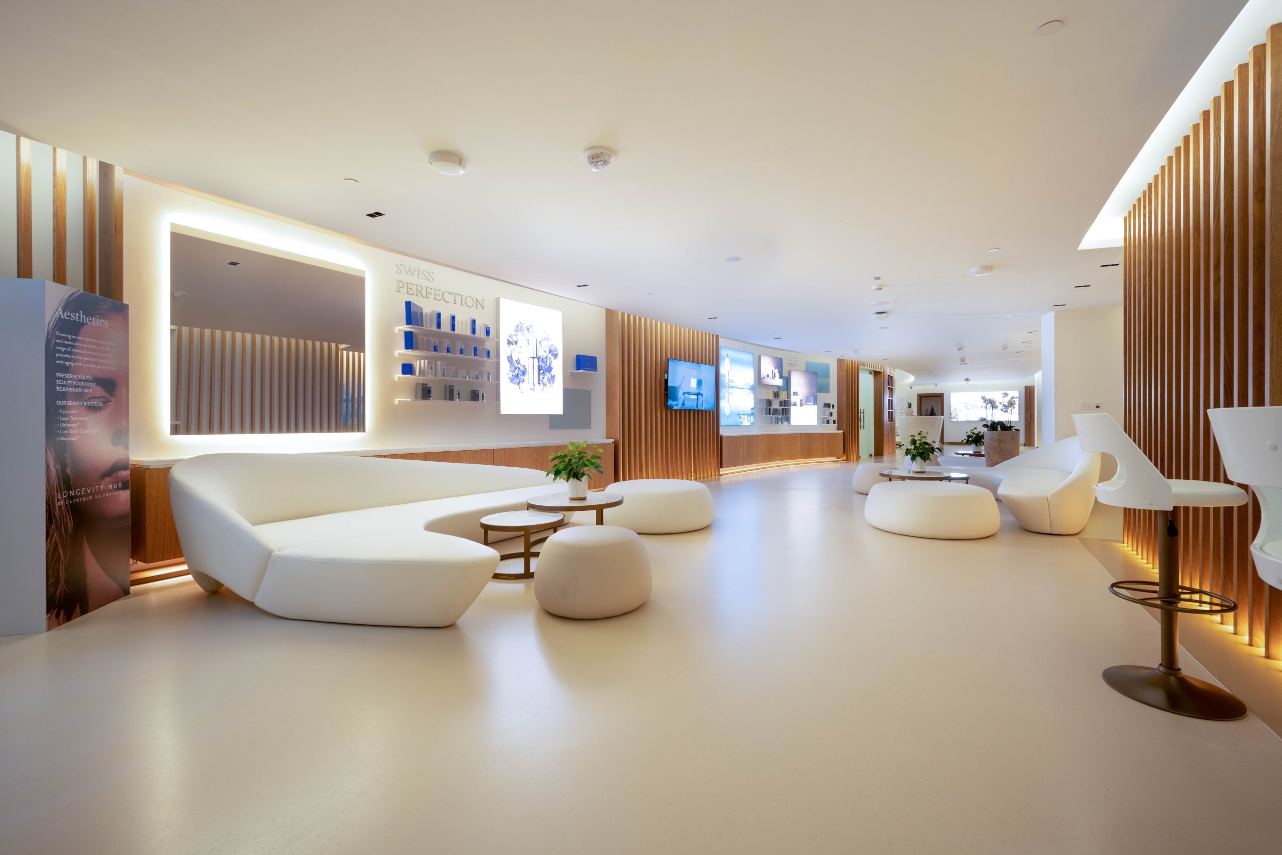 Modern lounge area with white seating and warm lights