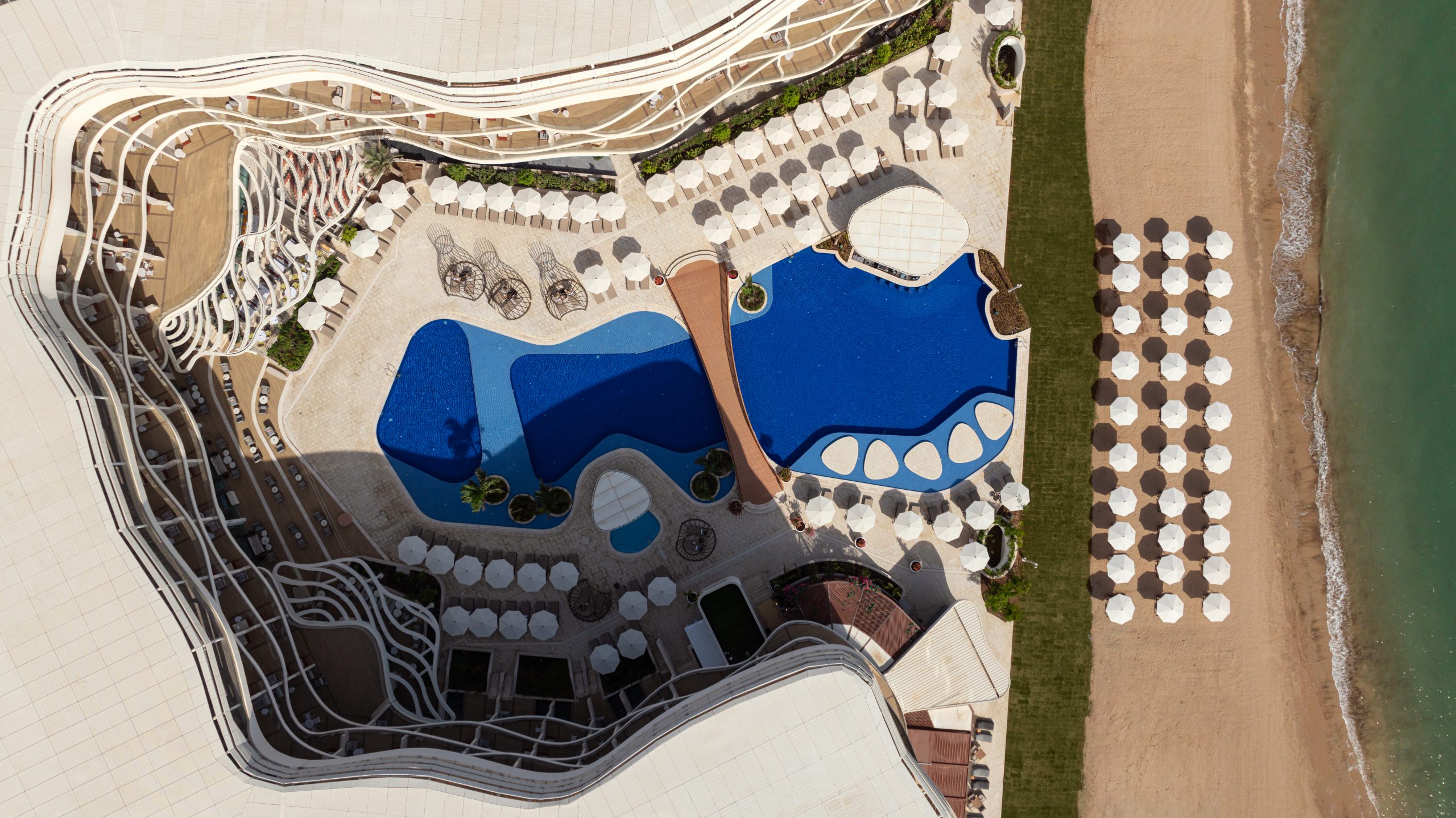 Aerial view of St. Regis pool and beach umbrellas