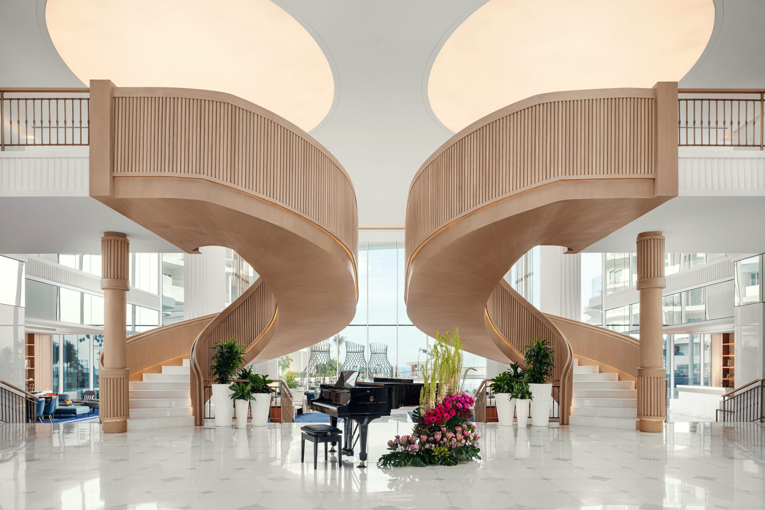 Elegant lobby with grand piano and twin staircases