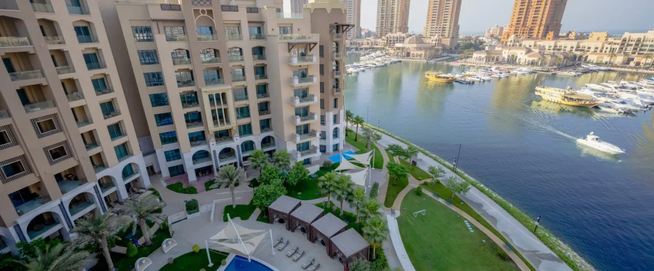Luxury pool and marina view with garden and buildings
