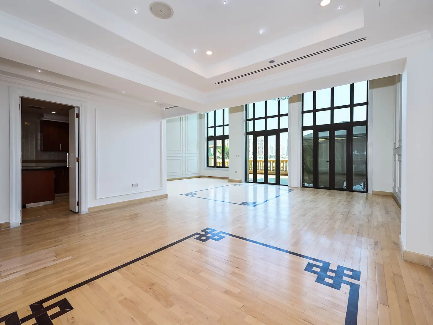 Spacious bright room with wood floor and large windows