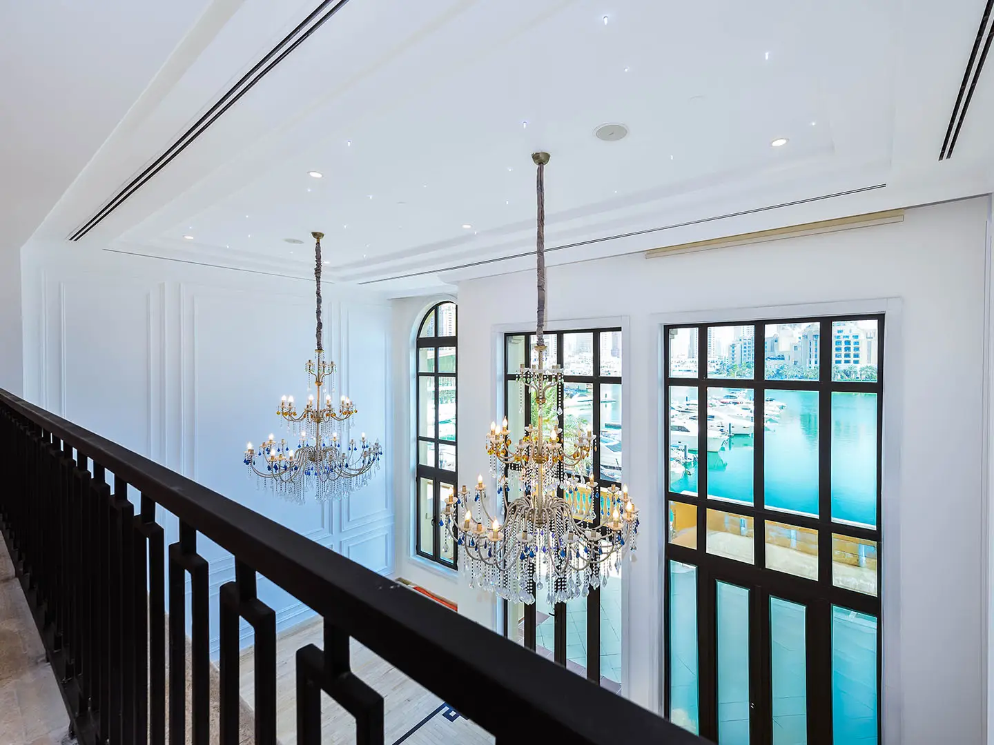 Elegant chandeliers in bright room with marina view