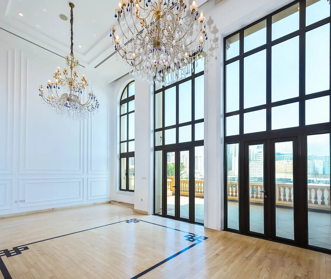 Bright room with chandeliers and large windows