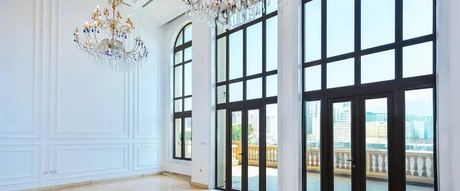 Bright room with chandeliers and large windows