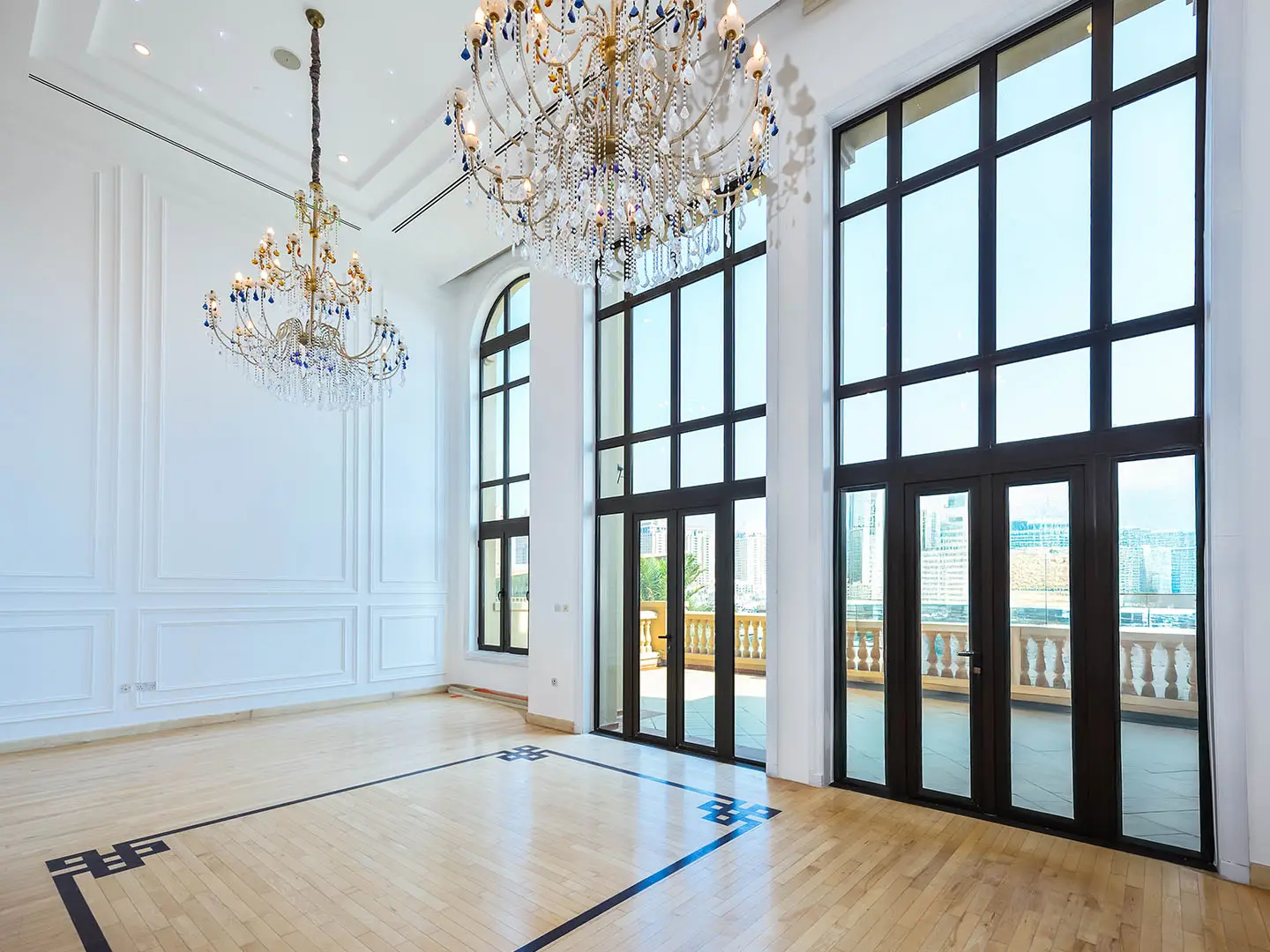 Bright room with chandeliers and large windows