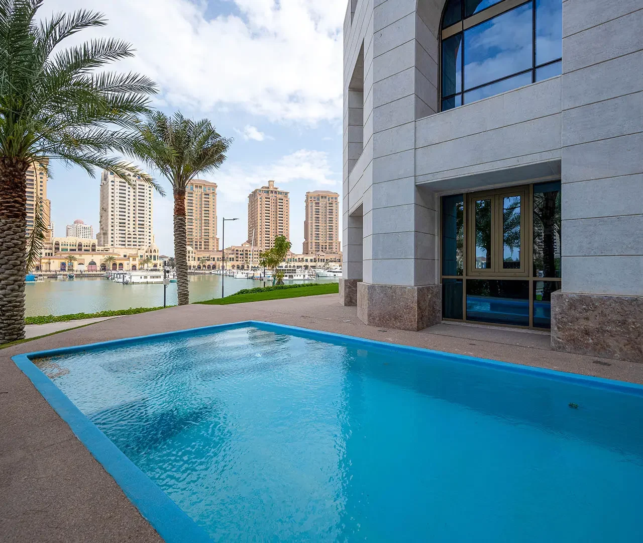Calm pool next to modern building, city view