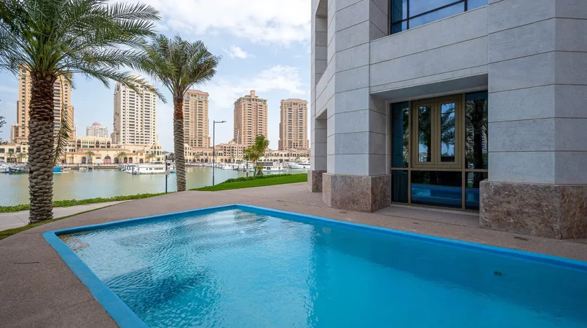 Calm pool next to modern building, city view