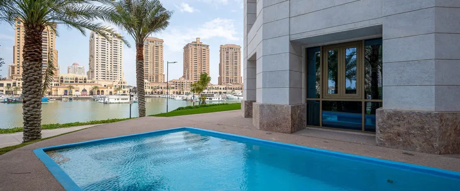 Calm pool next to modern building, city view