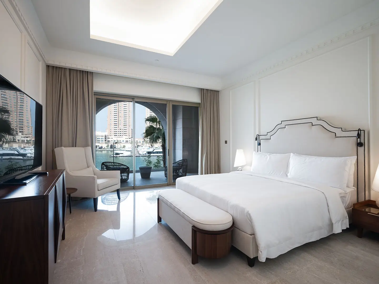 Cozy chair faces serene marina through glass