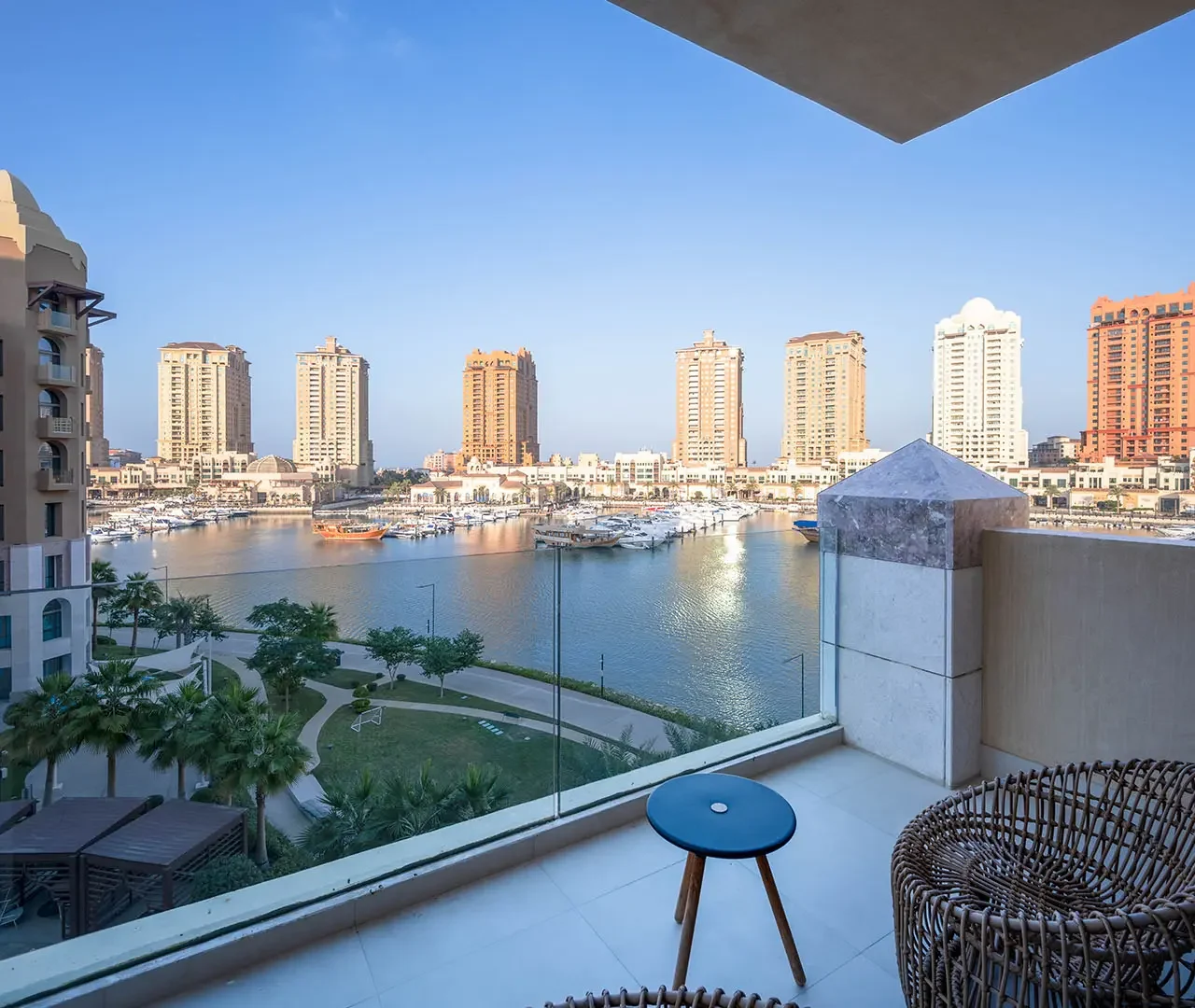 Balcony seating facing tall buildings and water
