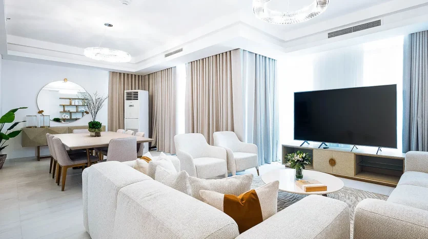 Comfortable sofas near TV and dining set