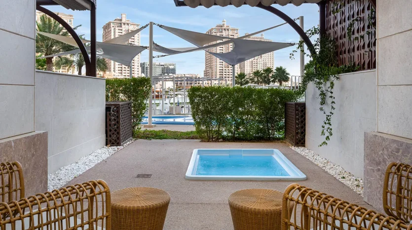 Covered patio with hot tub and seating