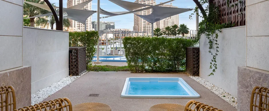 Covered patio with hot tub and seating