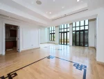 Spacious bright room with wood floor and large windows