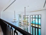 Elegant chandeliers in bright room with marina view