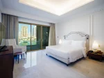 Bright bedroom with marina view through glass doors