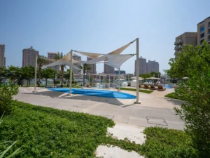 Outdoor pool with white canopy shades