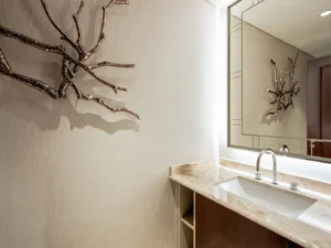 Elegant sink area with lit mirror and decor