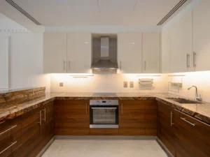Kitchen with marble counters and stainless hood
