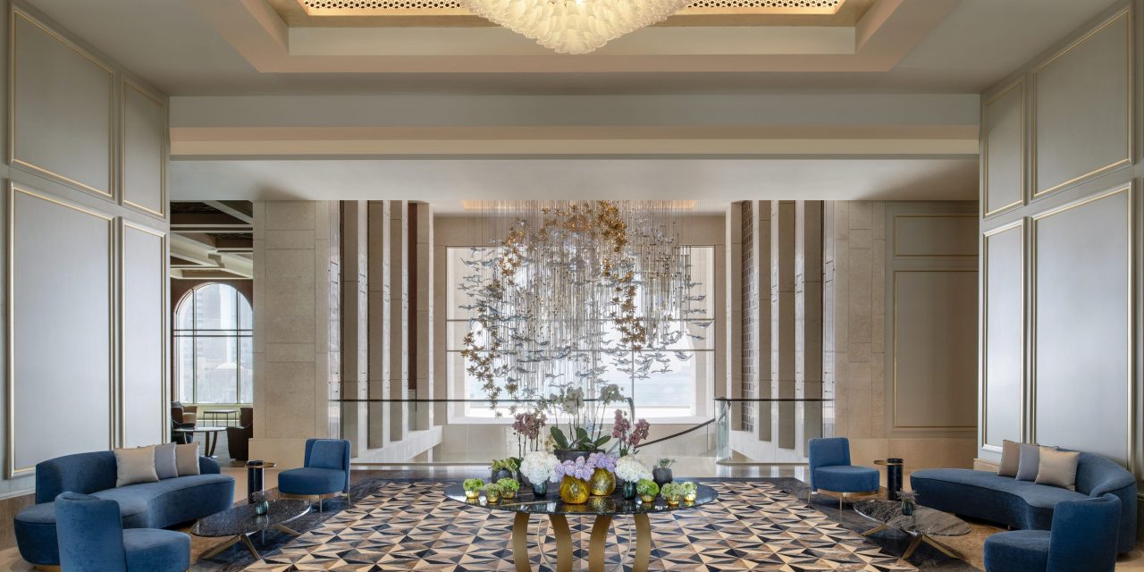 Opulent hotel lobby with blue sofas and chandelier