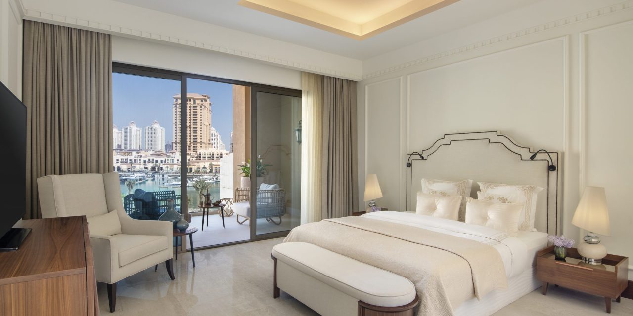 Bedroom with balcony, bed, and marina view