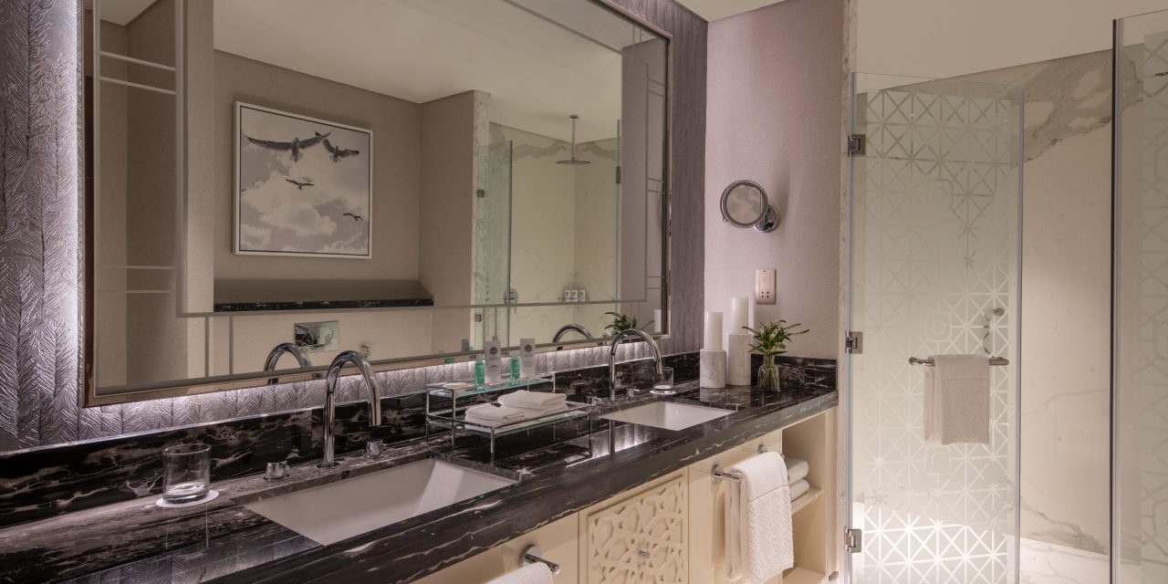 Luxurious hotel bathroom with double vanity and large mirror